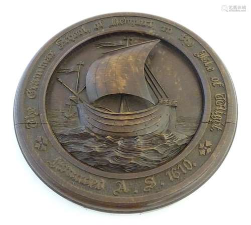 A carved wooden roundel depicting a nautical scene with sailing boat at sea in high relief, the