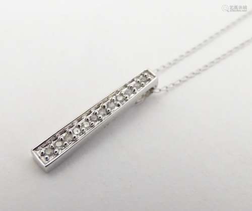 A 9ct white gold necklace and pendant, the pendant set with 12 linear set diamonds. 18