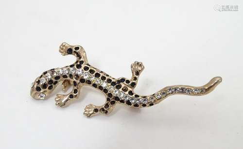 A vintage brooch formed as a lizard, the eyes and back line detailed with white stones. Approx. 2?