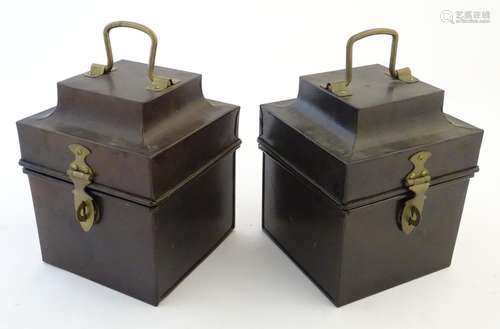 A pair of tin boxes / caddies, each with a hinged lid, handle and catch. Approx. 7 1/2'' tall. (2)