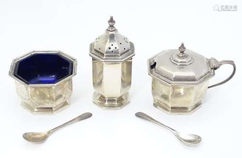 An Art Deco silver three piece cruet set comprising salt, pepper and mustard pot, the salt and