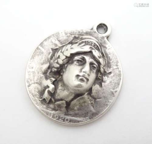 A white metal pendant inspired by an American coin. 1 1/4