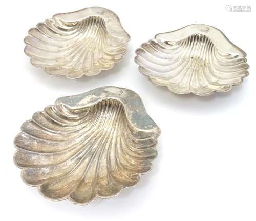 A set of three Elkington Plate silver plate butter dishes of Scallop shell form with engraved