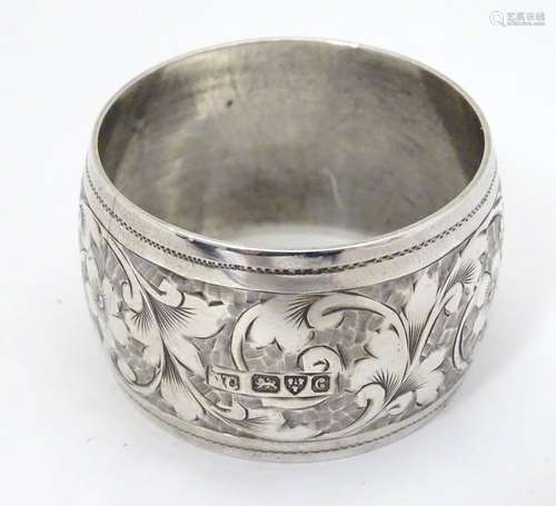 A silver napkin ring with engraved decoration, hallmarked Chester 1903 Please Note - we do not