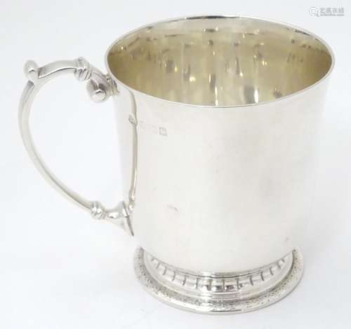 A silver christening mug / tankard, hallmarked Birmingham 1941, maker Adie Brothers Ltd. Approx. 3