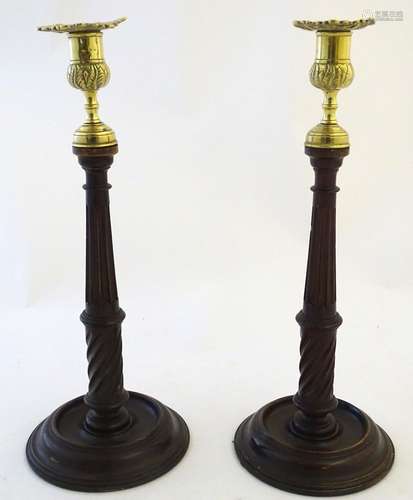 A pair of 20thC oak candlesticks with brass sconces with foliate detail. Approx. 13 1/2