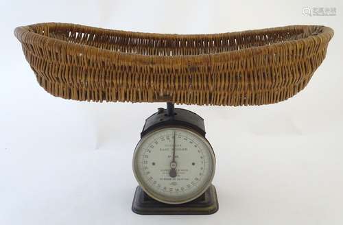 An early 20thC Hughes's Baby Weigher / weighing scales with a wicker basket by Salter. Model no. 48.