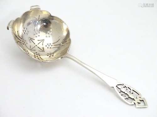 A silver tea strainer with pierced decoration. Hallmarked Sheffield 1954 maker HH. 42g Please Note -