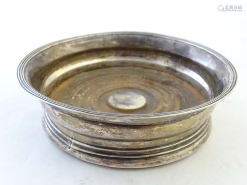 A Geo III Scottish silver coaster with turned wooden base with roundel to centre with engraved