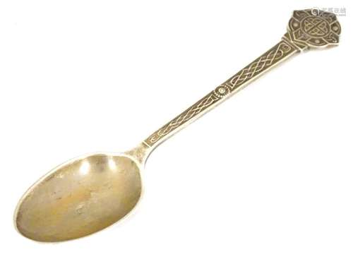 A silver teaspoon with Celtic decoration and engraved M.L.G.C (possibly Mount Lawley Golf Club ).