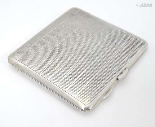 An Art Deco Silver cigarette case with engine turned decoration. Hallmarked Birmingham 1939 maker