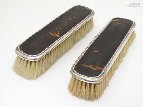 A pair of silver and tortoiseshell backed clothes brushes. Hallmarked Birmingham 1919, maker W. G.