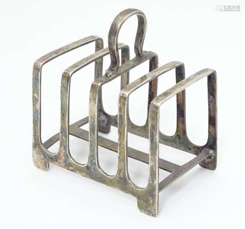 A silver four division toast rack. Hallmarked Sheffield 1936, maker James Dixon & Sons. Approx. 3?