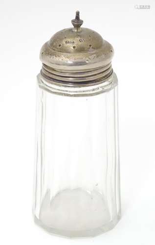 A cut glass sugar shaker with silver lid, hallmarked Birmingham 1909, maker C&C Ltd. Approx. 5 1/