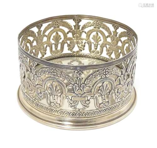 A white metal .800 silver bottle coaster / decanter stand with openwork decoration. Approx. 4 1/4