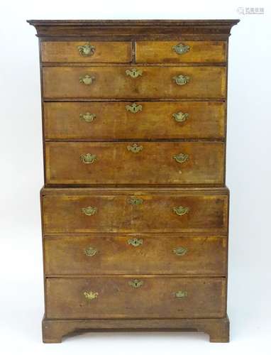 An 18thC oak chest on chest with a moulded cornice above two short over six long graduated drawers