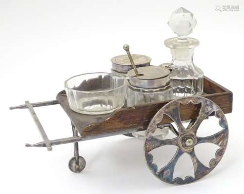 A Victorian glass and silver plate novelty four piece cruet set, the wooden and silver plate stand