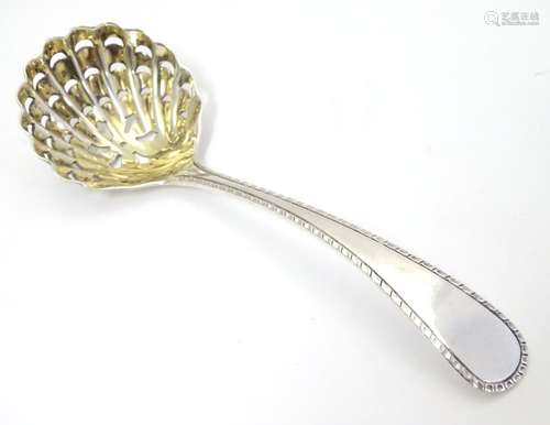 A silver sifter spoon with scallop shell formed bowl, hallmarked Birmingham 1938, maker Barker