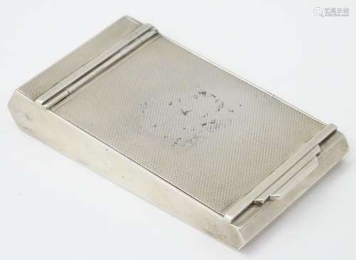 An Art Deco silver powder compact with engine turned decoration, hallmarked London 1952, maker