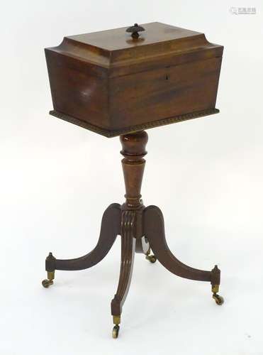 A Regency mahogany tea caddy on stand, with a sarcophagus shaped lid, egg and dart mouldings and