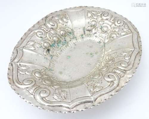 A silver plate dish of oval form with embossed decoration. Approx. 12