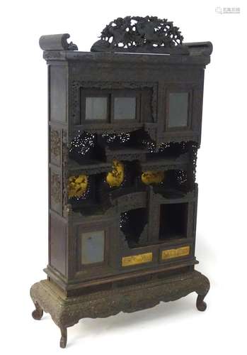 A 19thC Japanese Shodhana cabinet with a carved up stand depicting birds and foliage. Having a