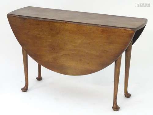 A 19thC mahogany drop leaf table with turned tapering legs terminating in pad feet. 48