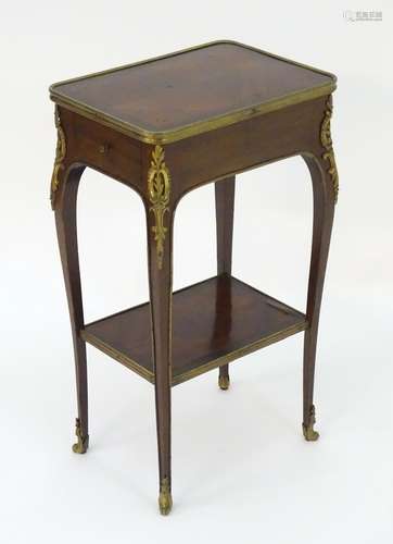 A 19thC mahogany table with ormolu banding and mounts above a single short drawer, cabriole legs and