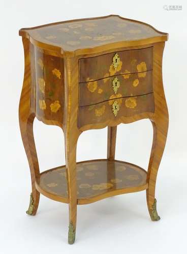 A 19thC satinwood ladies writing table with a shaped top and three short drawers all having floral