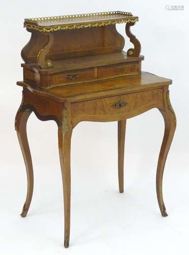 A 19thC burr walnut Bonheur du jour with brass gallery and hanging ormolu swags with scrolled