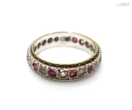 A 9ct white gold eternity ring set with band of red and white stones. Ring size approx N Please Note