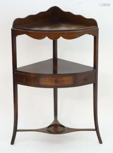 A 19thC mahogany corner washstand with a shaped upstand above two tiers, the lower tier having a