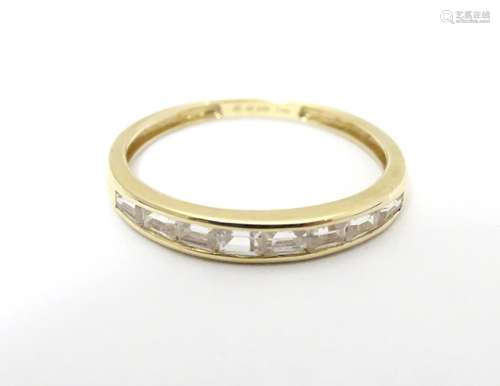 A 14ct gold ring set with white stones. Ring size approx size R. Please Note - we do not make