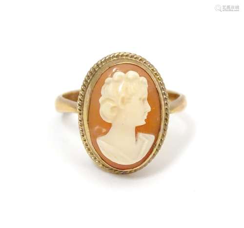 A 9ct gold ring set with cameo. Ring size approx size L Please Note - we do not make reference to