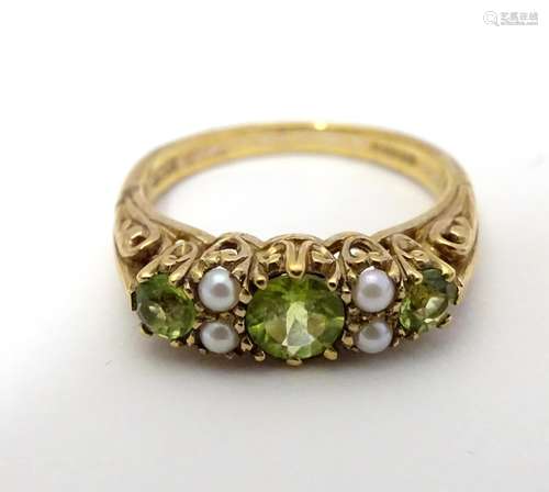 A 9ct gold ring set with peridot and seed pearls Ring size approx O Please Note - we do not make