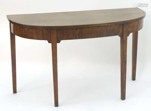 A 19thC mahogany Victorian demilune table raised on tapering legs. 49