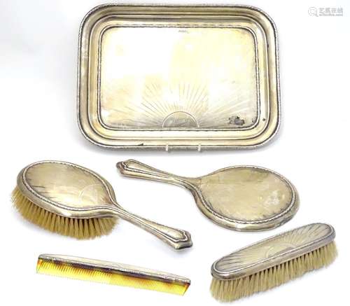 An Art Deco silver dressing table set comprising tray, brushes and com with engine turned