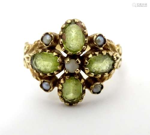 A 9ct gold ring set with peridot and seed pearl. Ring size approx size O. Please Note - we do not