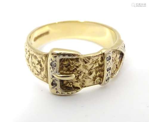 A 9ct gold ring of belt and buckle form with floral detail and chip set diamonds. Please Note - we