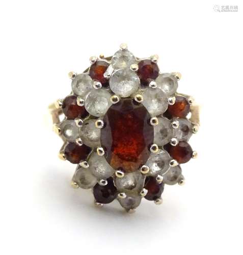 A 9ct gold ring set with red and white stones. ring size approx size L. Please Note - we do not make