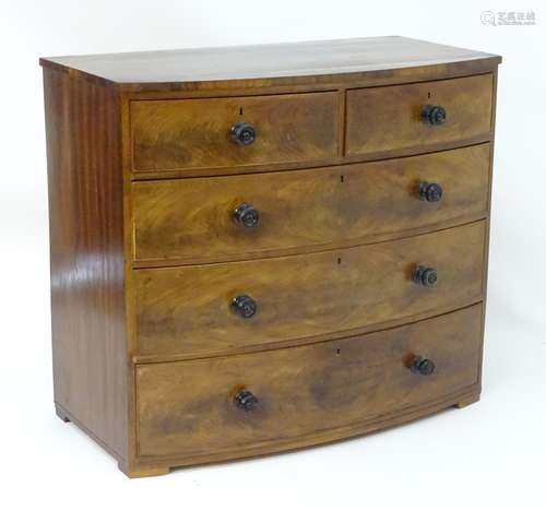 A Victorian mahogany bow fronted chest of drawers comprising two short over three long drawers