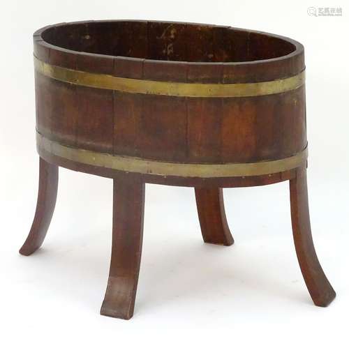 An 18thC coopered cellarette, of mahogany construction with two brass bands, standing on four