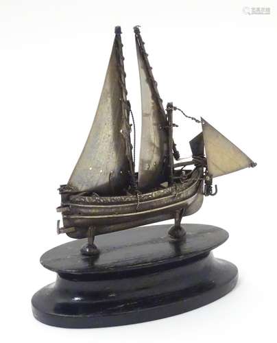 A Maltese silver model of a sailing boat, mounted on an ebonised base. The whole 4 1/2