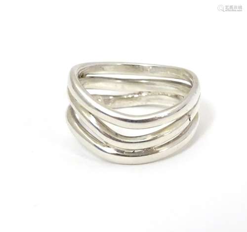 A silver ring formed as three joined wavy strands. Hallmarked London 2017, maker Amanda Birkett.