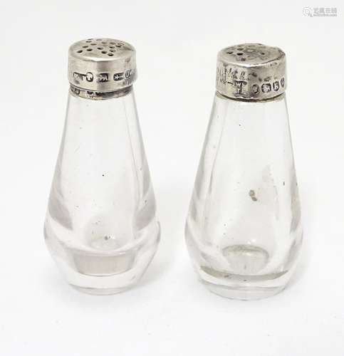 A pair of Victorian glass pepperettes with silver tops hallmarked London 1885 maker Jonathan