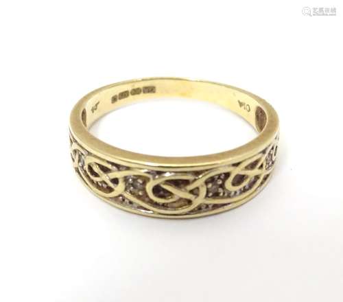 A 9ct gold ring with Celtic style decorationand chip set diamonds. Ring size approx size R 1 1/2