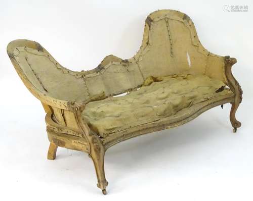 A Victorian walnut double hump back sofa for re-upholstery. 67