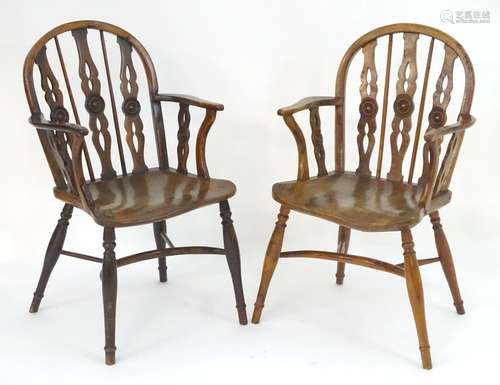 Two early / mid 19thC yew wood draught back Windsor chairs, with bowed backs and three carved back