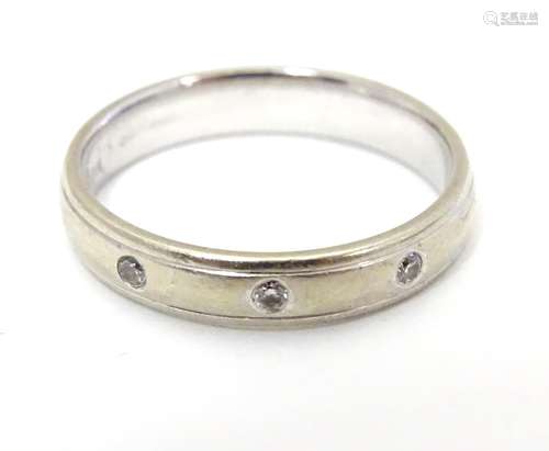 A white gold band set with 3 diamonds. Ring size approx size O. Please Note - we do not make