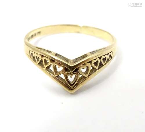 A 9ct gold ring whith heart detail. Ring size approx L 1/2 Please Note - we do not make reference to